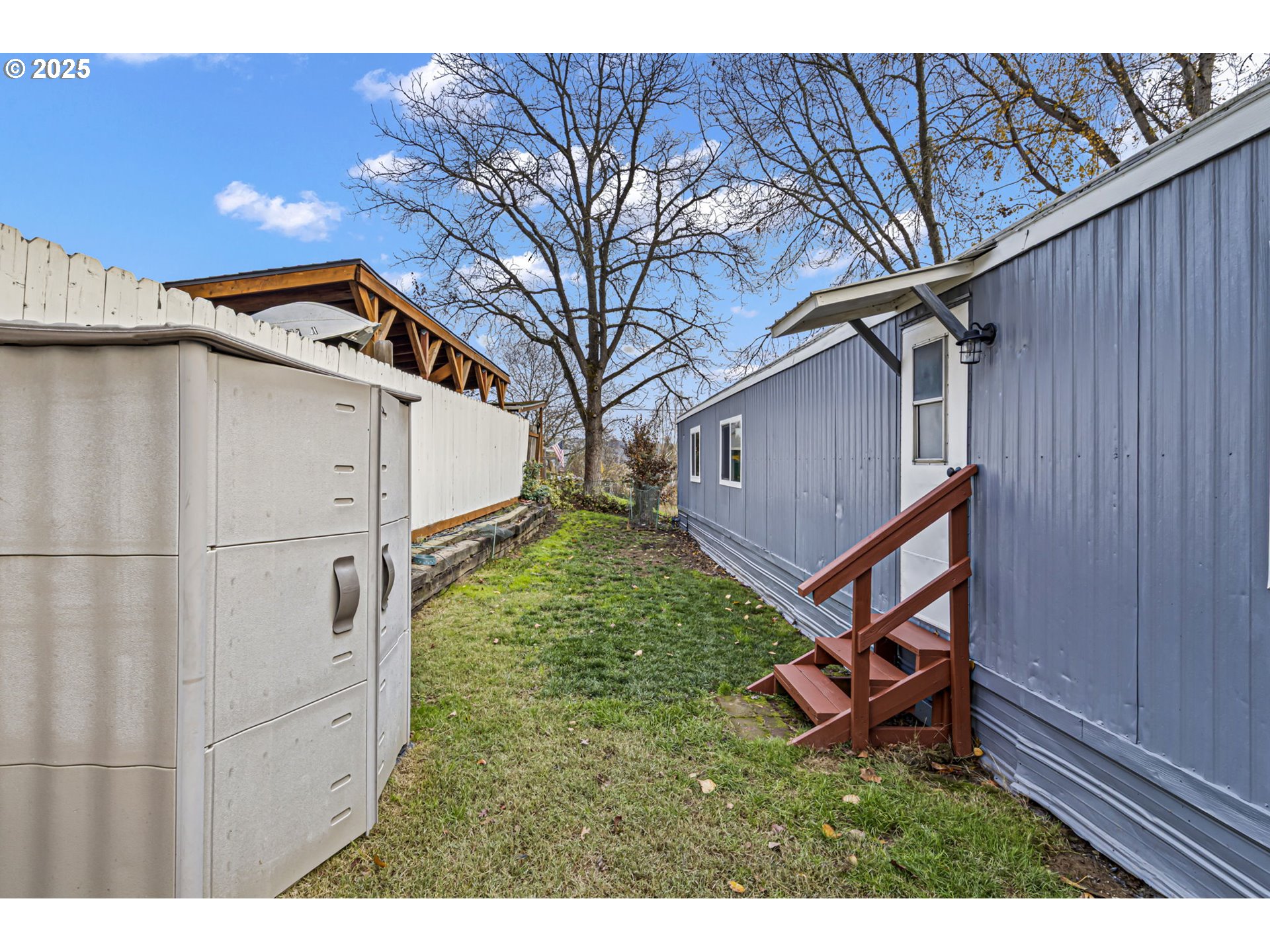 250 Northeast Jorgen Street Winston, OR 97496 - Photo 3 of 36 a backyard of a house with wooden floor and fence