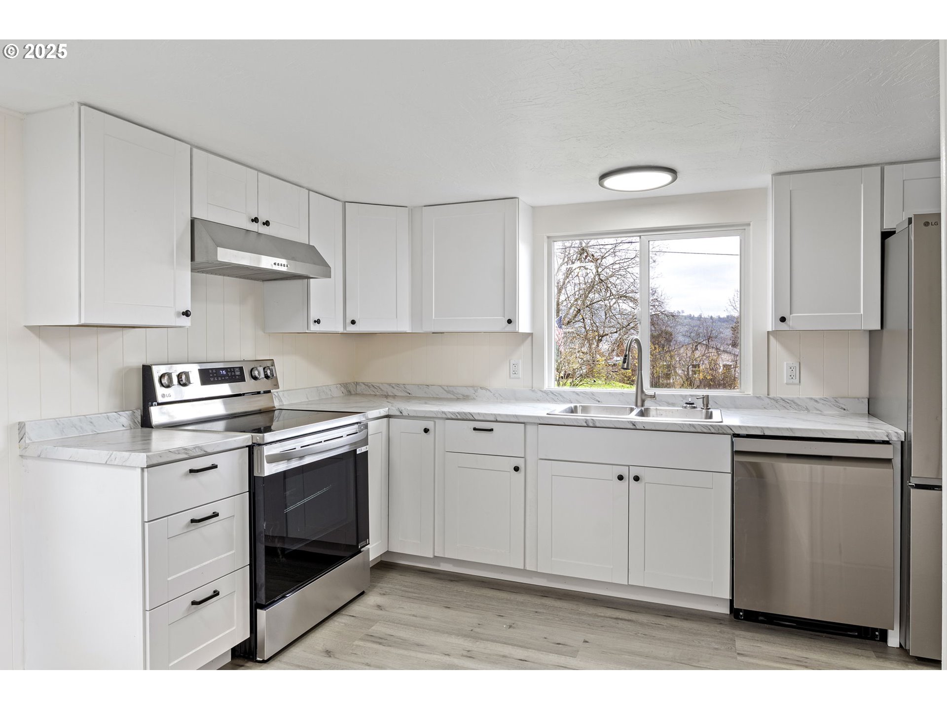 250 Northeast Jorgen Street Winston, OR 97496 - Photo 7 of 36 a kitchen with stainless steel appliances granite countertop a sink stove and refrigerator