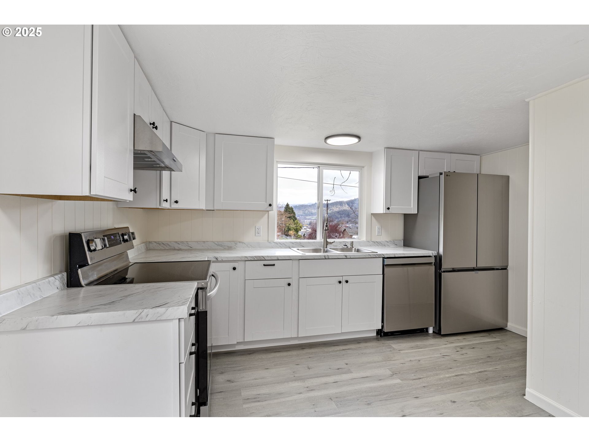 250 Northeast Jorgen Street Winston, OR 97496 - Photo 8 of 36 a kitchen with refrigerator and cabinets
