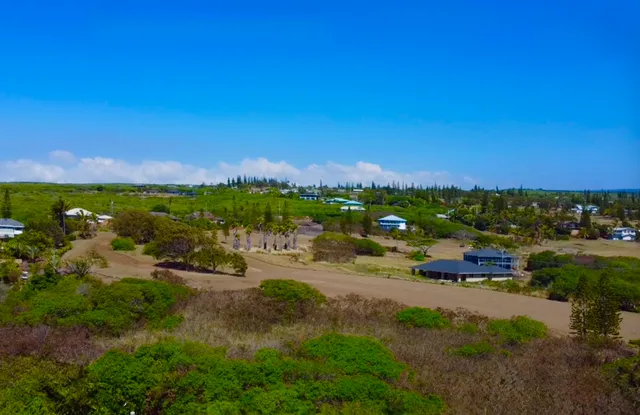 a view of a street with a yard
