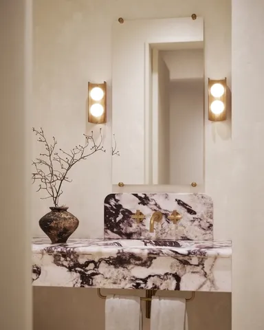 a living room with a fireplace and a walk in closet