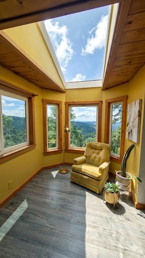 4850 8 Mile Road Camino, CA 95709 - Photo 23 of 30 a living room with furniture and floor to ceiling windows