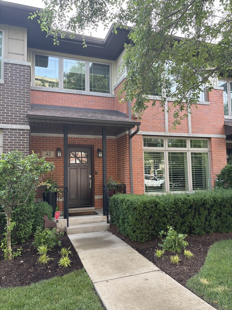 42 Meacham Avenue Park Ridge, IL 60068 - Photo 2 of 2 a front view of a house with garden