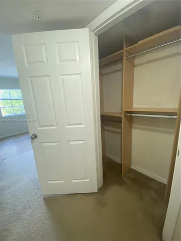 a bathroom with a granite countertop sink a toilet and mirror
