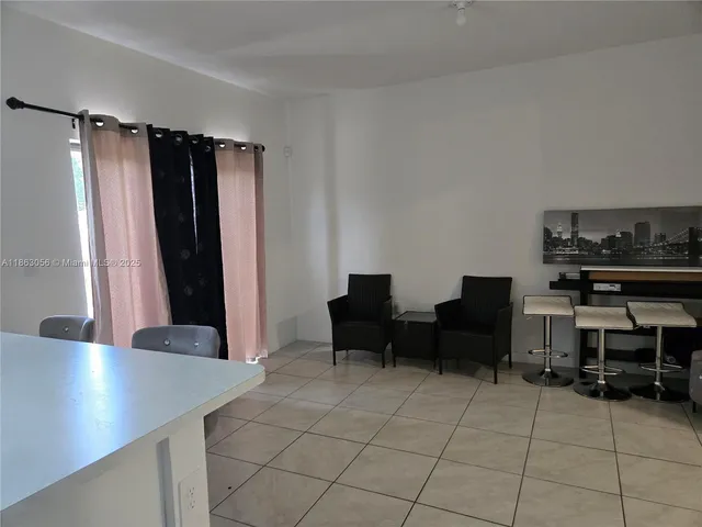 a view of a workspace with furniture and a potted plant