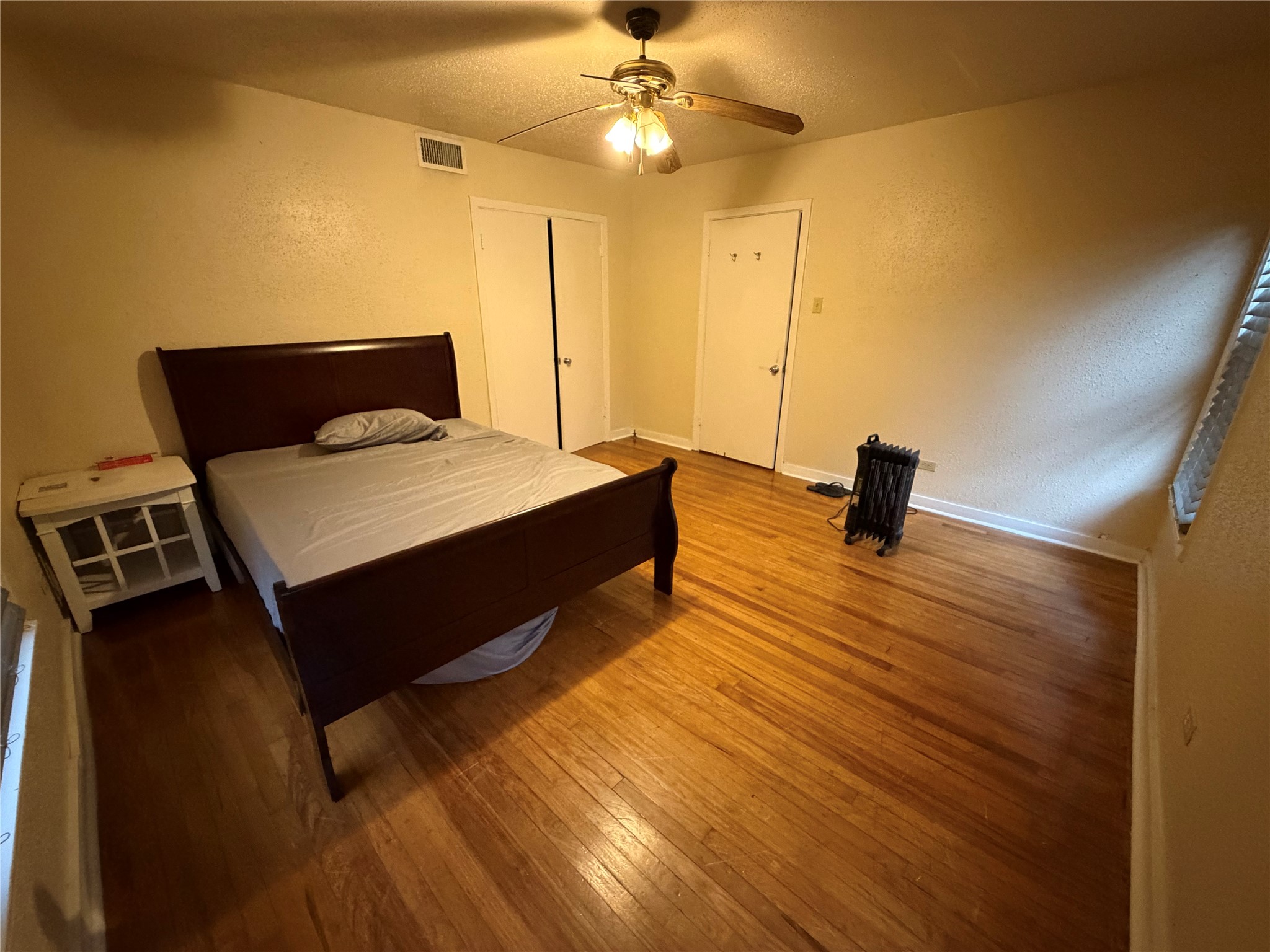 2406 Charleston Street Houston, TX 77021 - Photo 5 of 13 a bedroom with a bed and a chandelier