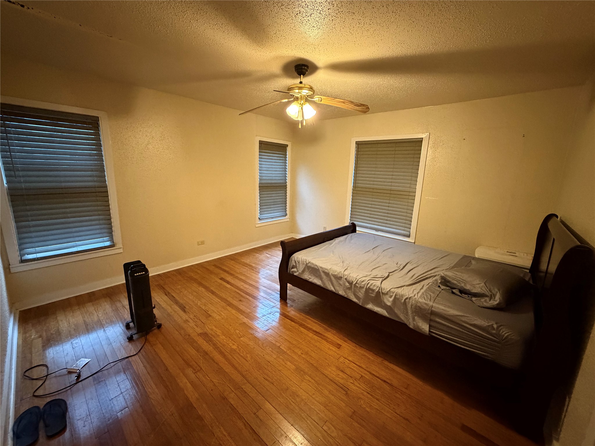 2406 Charleston Street Houston, TX 77021 - Photo 6 of 13 a bedroom with a bed and a chandelier