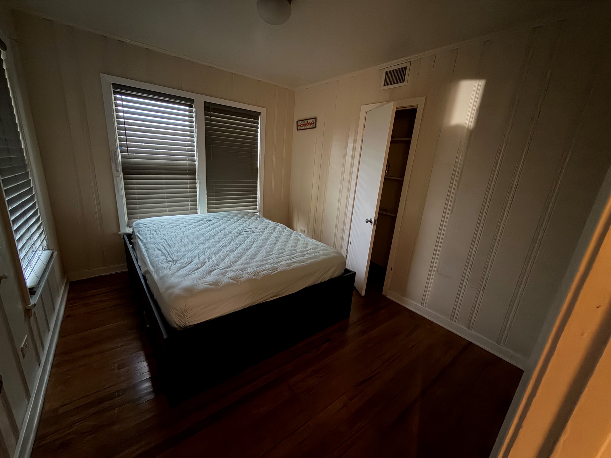 2406 Charleston Street Houston, TX 77021 - Photo 7 of 13 a bedroom with a bed and wooden floor