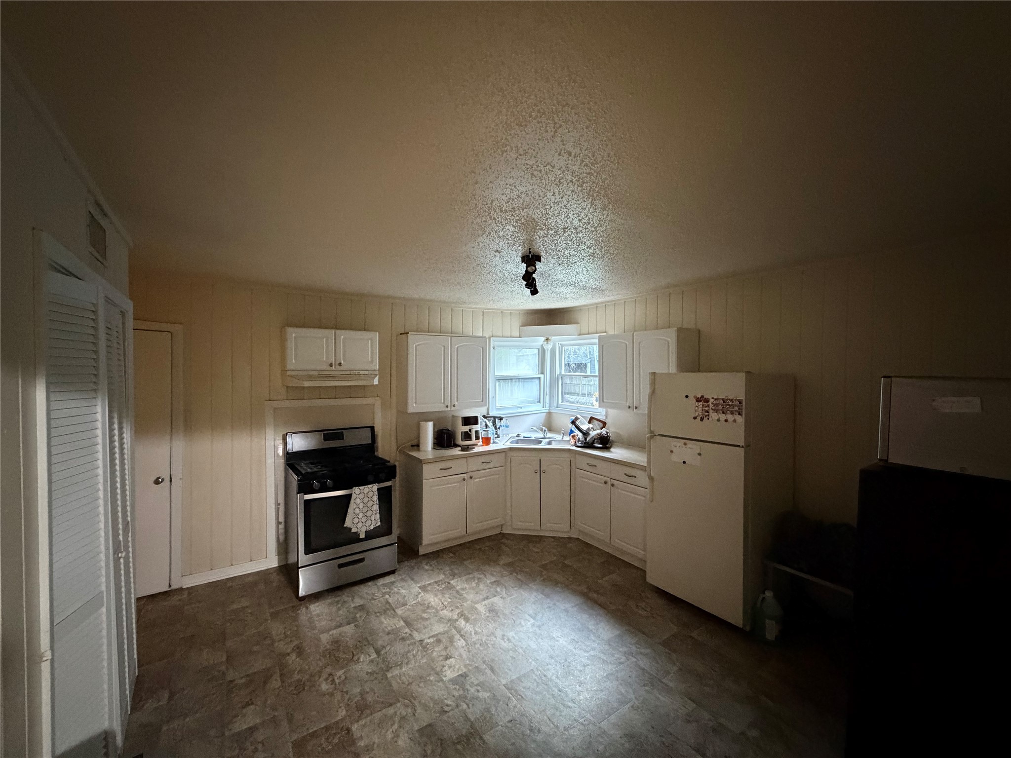2406 Charleston Street Houston, TX 77021 - Photo 9 of 13 a kitchen with a refrigerator and a stove top oven