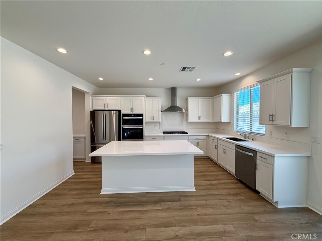 21624 Thomas Court Riverside, CA 92507 - Photo 8 of 36 a large kitchen with stainless steel appliances a large counter top a stove and a refrigerator