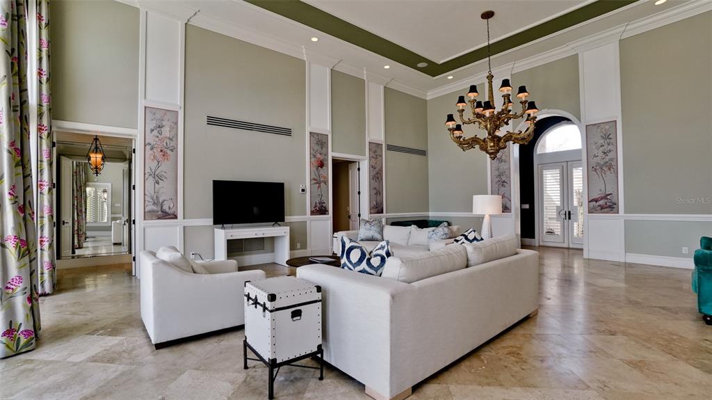 8213 Midnight Pass Road Sarasota, FL 34242 - Photo 11 of 52 a living room with furniture and a flat screen tv