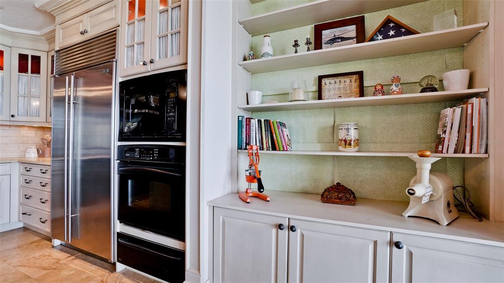 8213 Midnight Pass Road Sarasota, FL 34242 - Photo 17 of 52 a kitchen with a refrigerator and cabinets