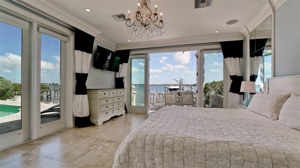 8213 Midnight Pass Road Sarasota, FL 34242 - Photo 21 of 52 a large bedroom with a large bed and a large window