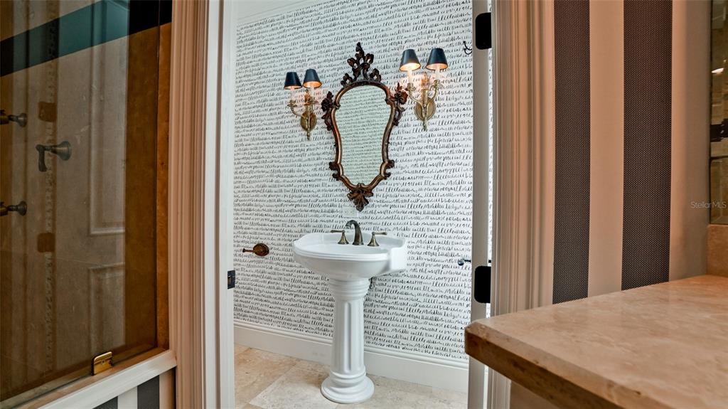 8213 Midnight Pass Road Sarasota, FL 34242 - Photo 27 of 52 a bathroom with a sink and mirror