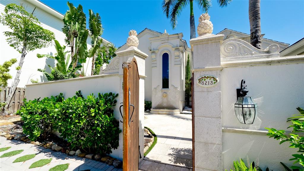 8213 Midnight Pass Road Sarasota, FL 34242 - Photo 3 of 52 a front view of a house with garden