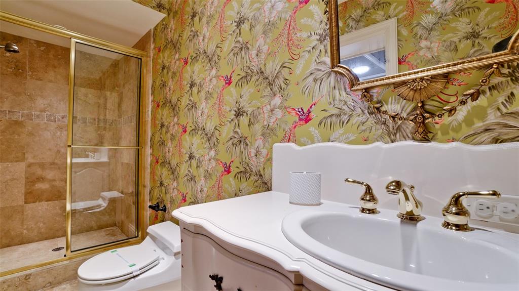 8213 Midnight Pass Road Sarasota, FL 34242 - Photo 32 of 52 a bathroom with a sink toilet and shower