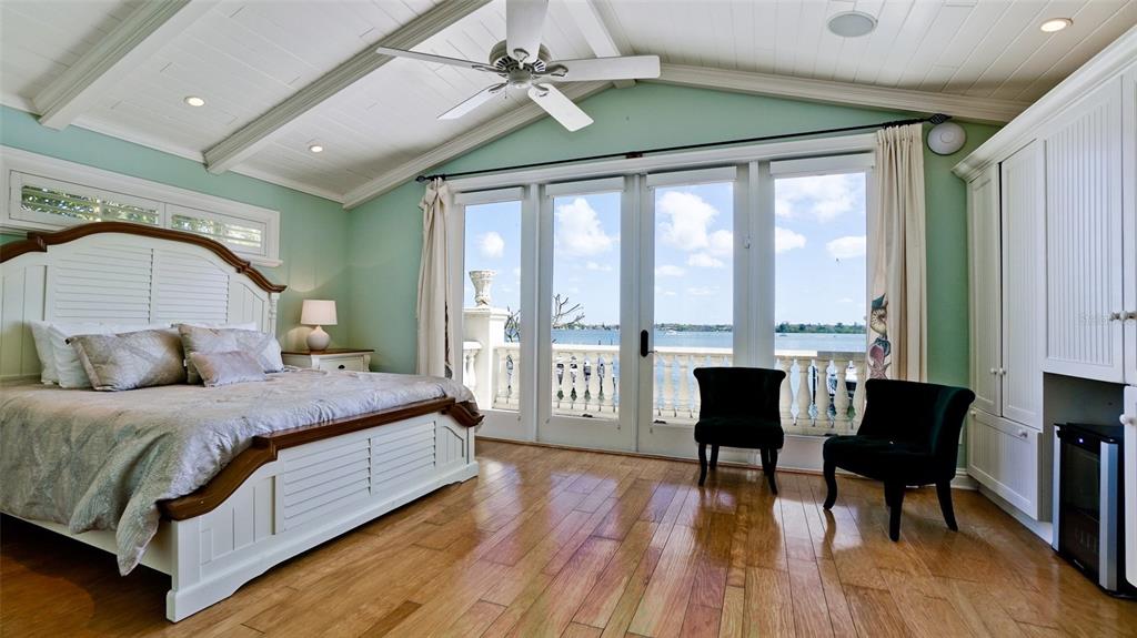 8213 Midnight Pass Road Sarasota, FL 34242 - Photo 36 of 52 a bedroom with a bed a table and a large window