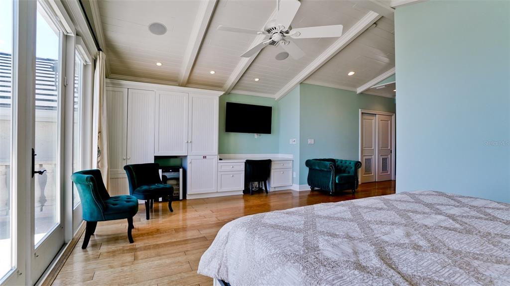 8213 Midnight Pass Road Sarasota, FL 34242 - Photo 37 of 52 a bedroom with a bed and a flat screen tv