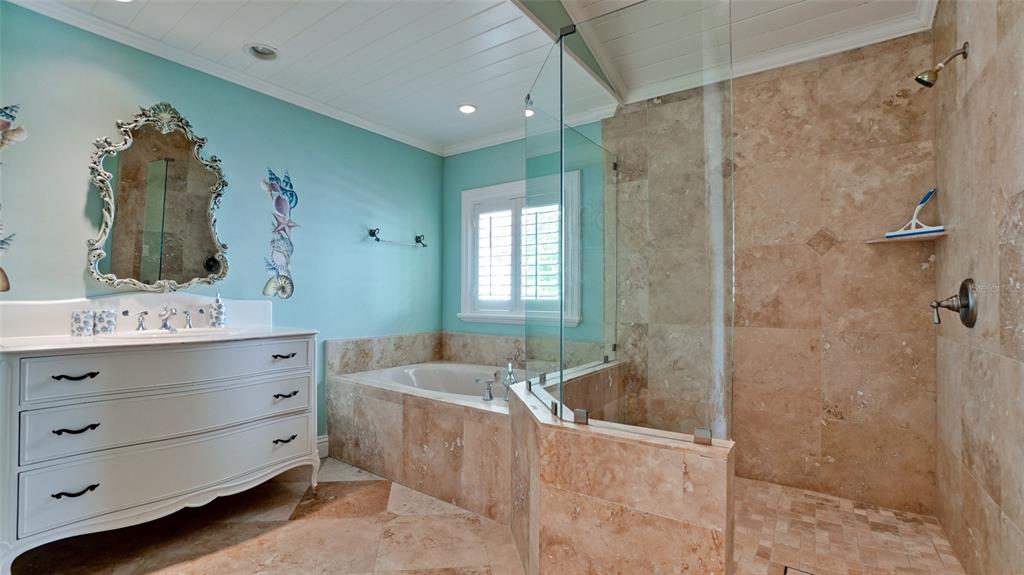 8213 Midnight Pass Road Sarasota, FL 34242 - Photo 40 of 52 a bathroom with a tub sink and mirror