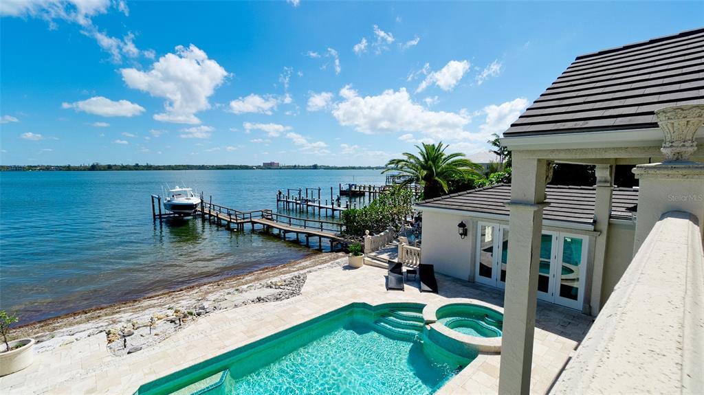 8213 Midnight Pass Road Sarasota, FL 34242 - Photo 42 of 52 a view of a swimming pool with a patio