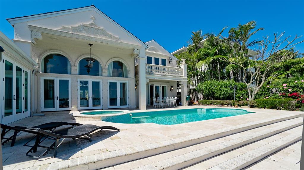 8213 Midnight Pass Road Sarasota, FL 34242 - Photo 44 of 52 a front view of residential houses with yard and green space