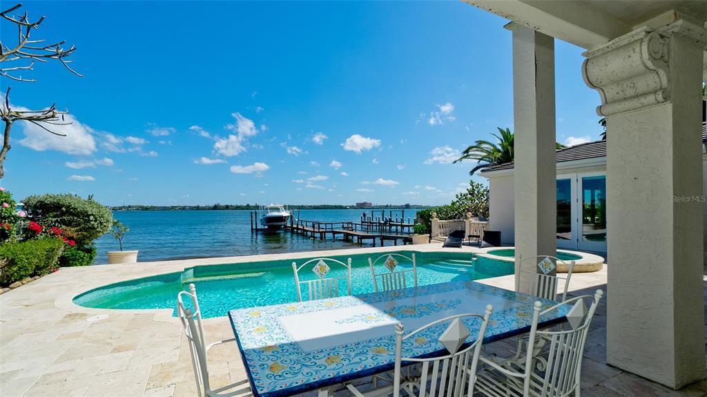 8213 Midnight Pass Road Sarasota, FL 34242 - Photo 52 of 52 a view of a chairs and table in patio with a swimming pool
