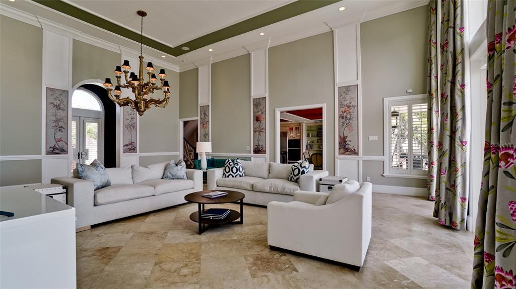 8213 Midnight Pass Road Sarasota, FL 34242 - Photo 10 of 52 a living room with furniture flowerpot and a chandelier