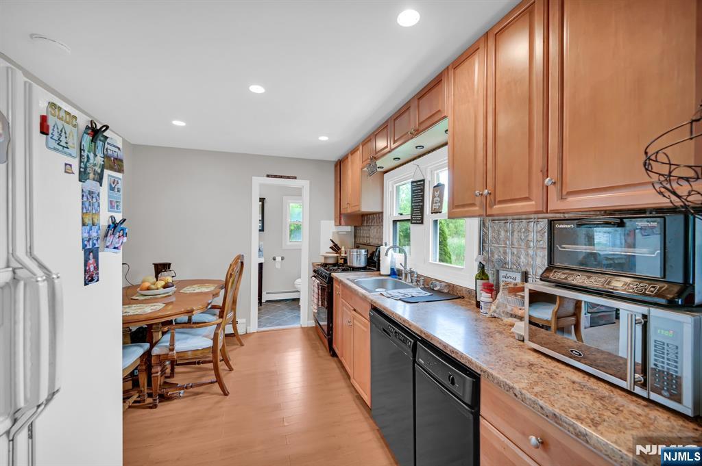 3 Riverside Road West Milford, NJ 07421 - Photo 14 of 29 a kitchen with stainless steel appliances granite countertop sink stove top oven and cabinets