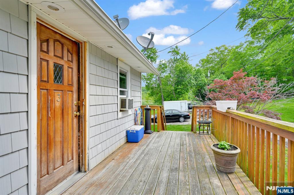 3 Riverside Road West Milford, NJ 07421 - Photo 22 of 29 a view of a chair and table on the wooden deck
