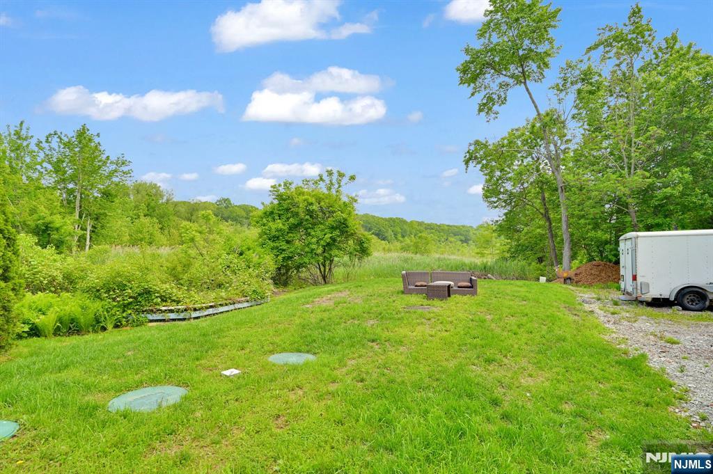 3 Riverside Road West Milford, NJ 07421 - Photo 23 of 29 a backyard of a house with lots of green space