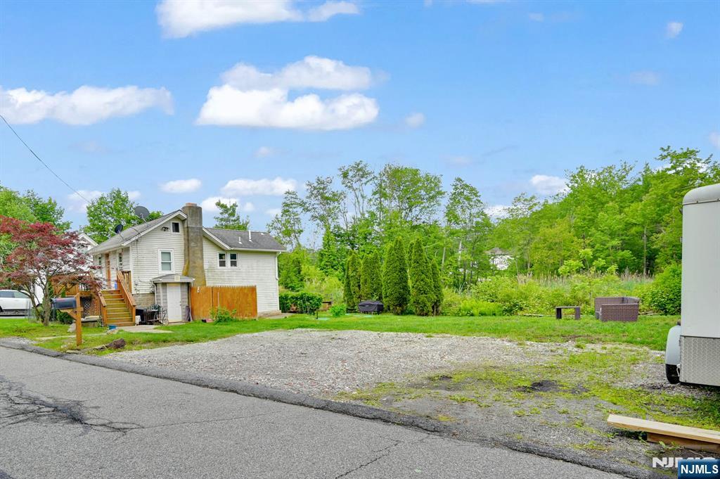 3 Riverside Road West Milford, NJ 07421 - Photo 3 of 29 a front view of a house with a yard and garage
