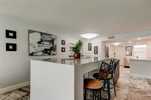 a living room with furniture and floor to ceiling windows