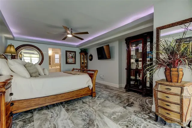 a bedroom with a large bed and a couch