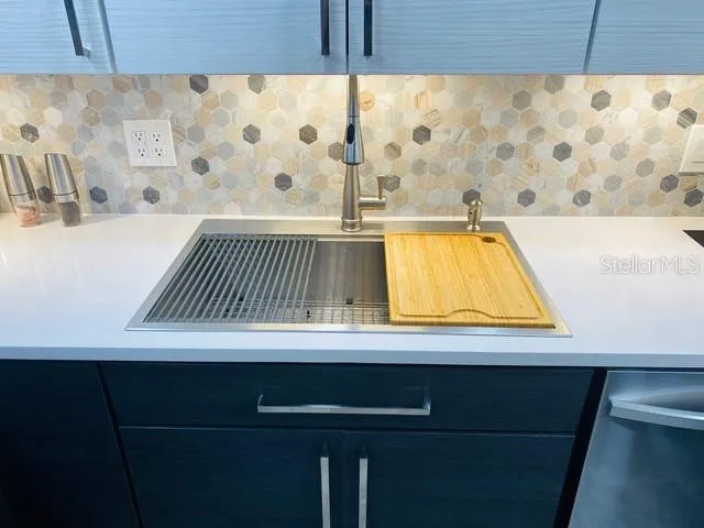 a kitchen with a sink cabinets and wooden floor