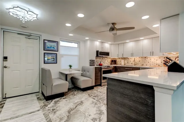 a view of a dining room with furniture and a potted plant