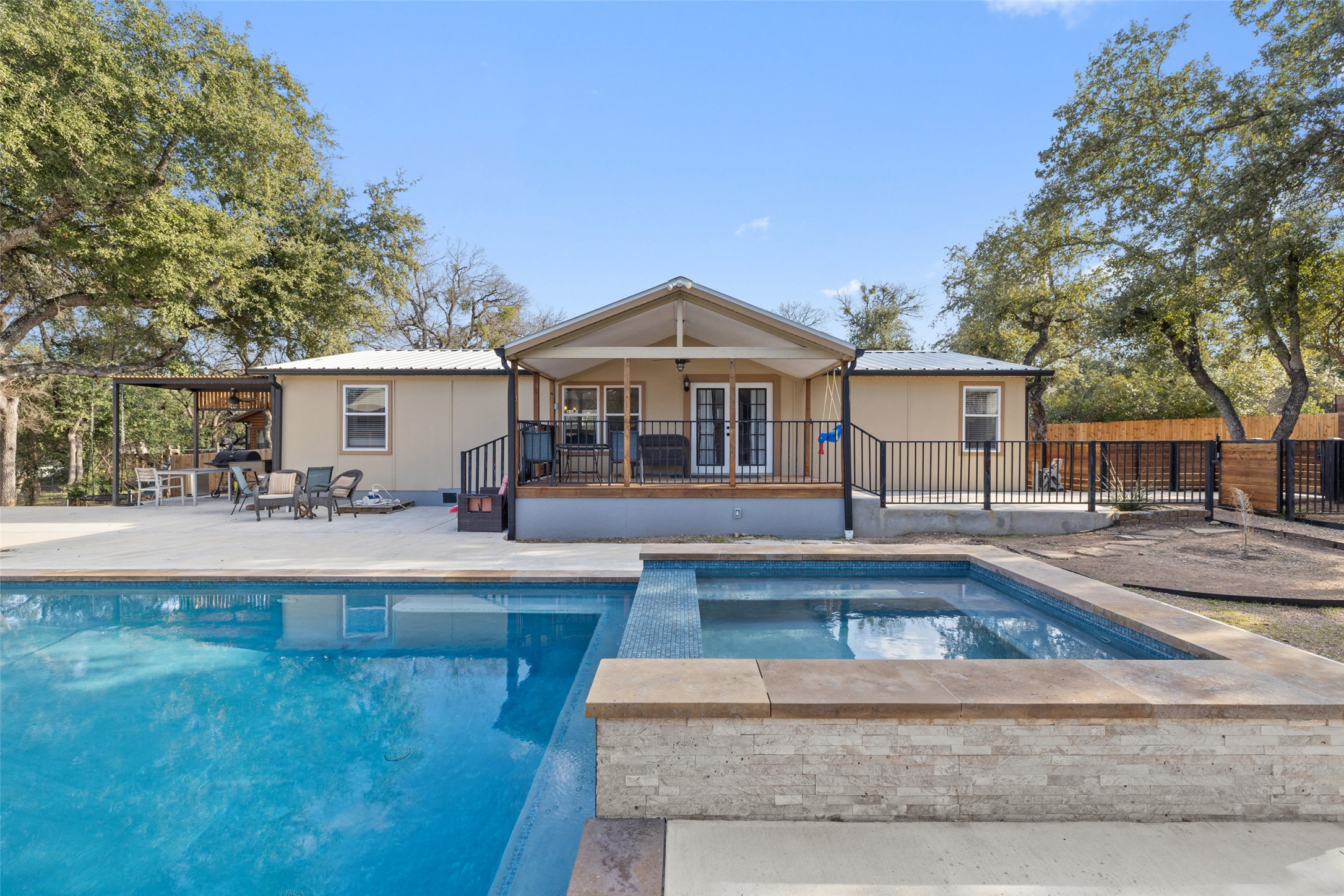 a swimming pool view with a seating space and a garden view