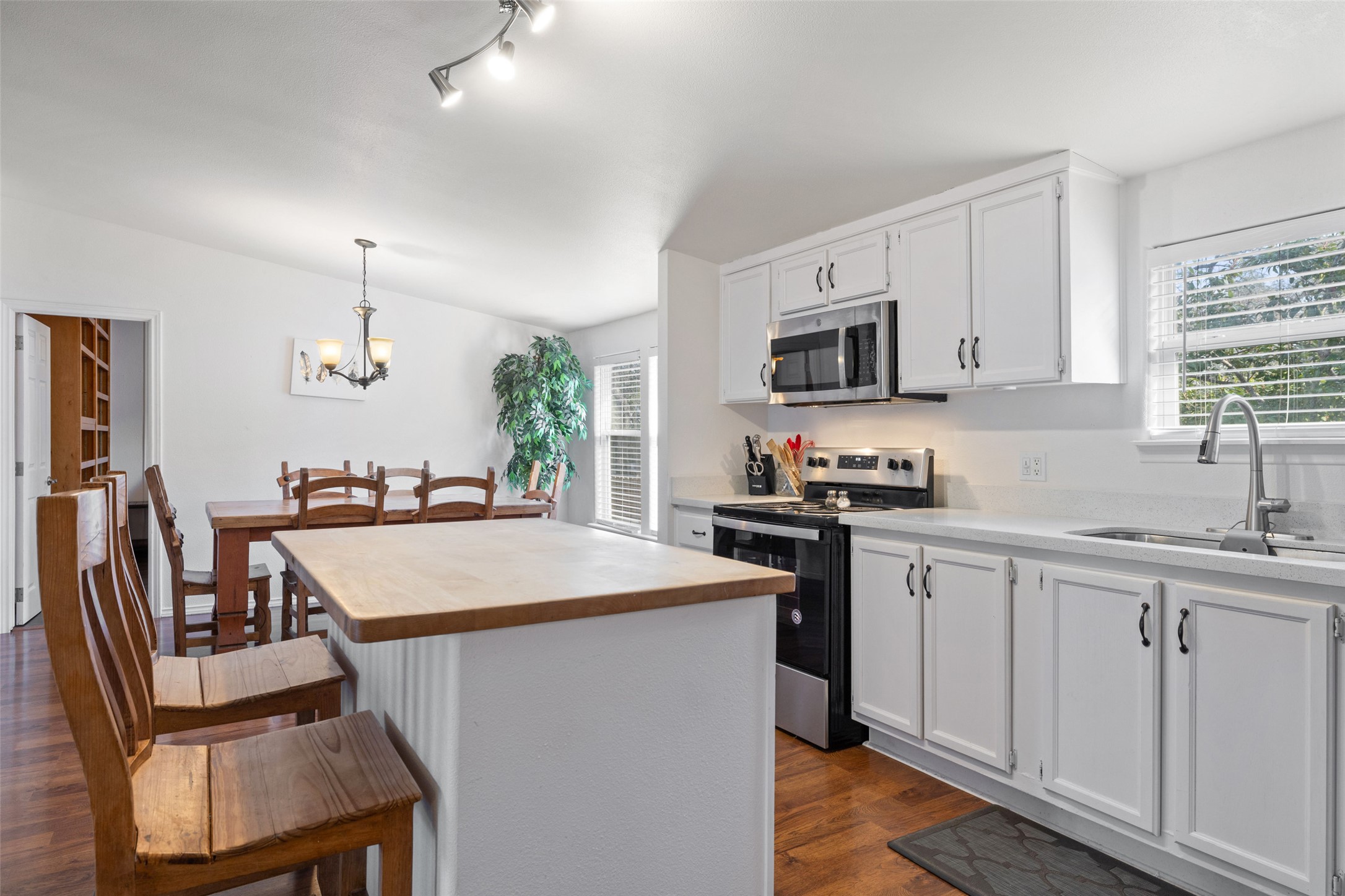 5519 Hiline Road Austin, TX 78734 - Photo 8 of 40 a kitchen with a stove a sink and a refrigerator