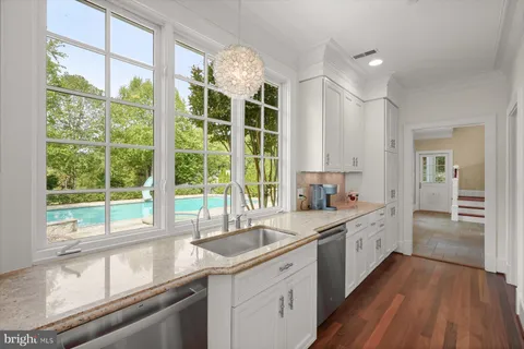 a kitchen with a sink and a large window