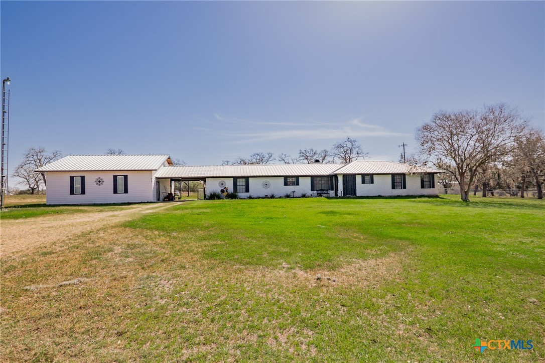455 Suncrest Lane Victoria, TX 77905 - Photo 2 of 39 a front view of a house with a yard table and chairs