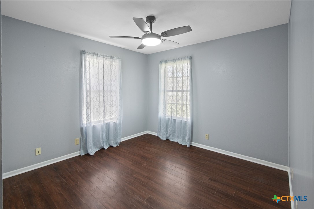 455 Suncrest Lane Victoria, TX 77905 - Photo 39 of 39 an empty room with wooden floor and windows