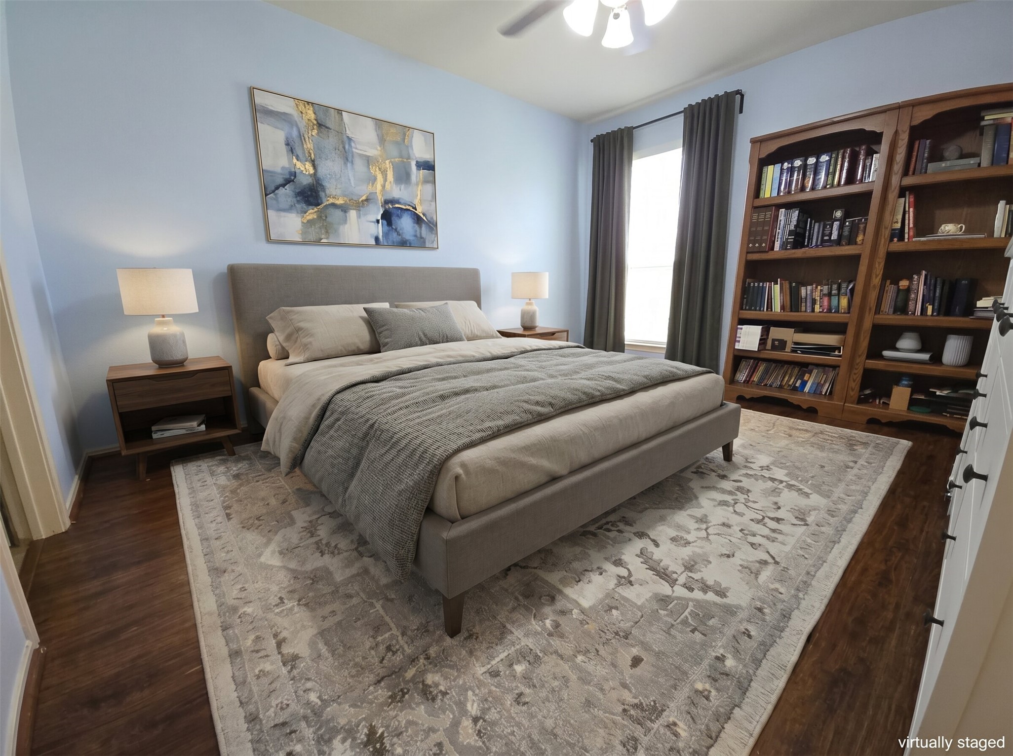 815 Bogart Road Cedar Park, TX 78613 - Photo 5 of 14 Hardwood flooring and light blue walls frame this inviting bedroom with a wide window.