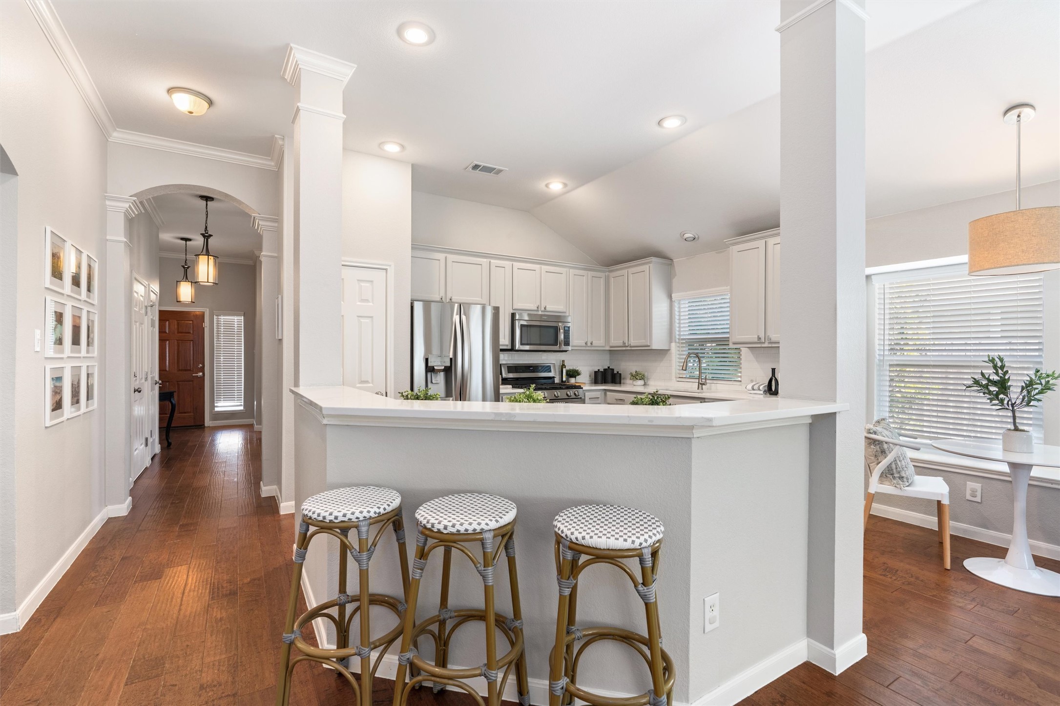 129 Summers Green Georgetown, TX 78633 - Photo 9 of 30 a kitchen with stainless steel appliances kitchen island granite countertop a dining table chairs and sink