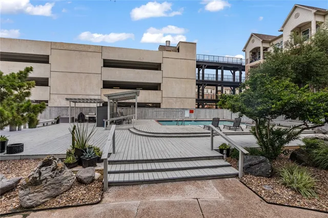 a view of a house with backyard sitting area and garden