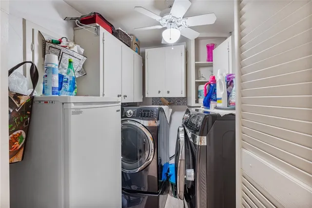 a view of a storage and utility room with washer and dryer