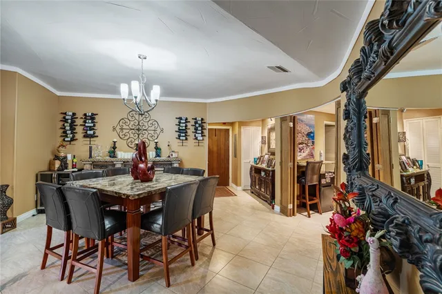a view of a dining room with furniture and chandelier