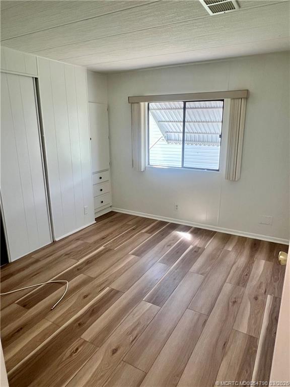 2692 Southwest Pontiac Place Stuart, FL 34997 - Photo 16 of 20 a view of a room with wooden floor and window