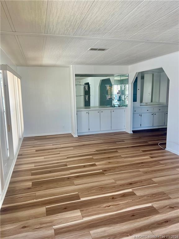 2692 Southwest Pontiac Place Stuart, FL 34997 - Photo 6 of 20 a view of a livingroom with wooden floor and cabinet