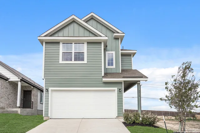 a front view of a house with a yard and porch