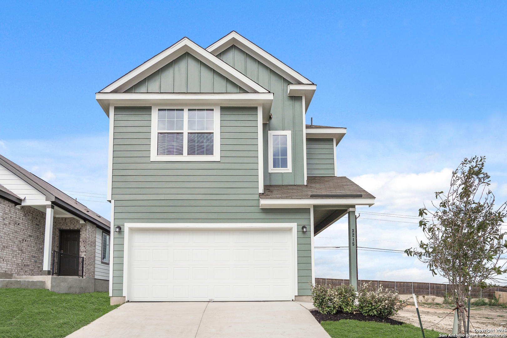 a front view of a house with a yard and porch