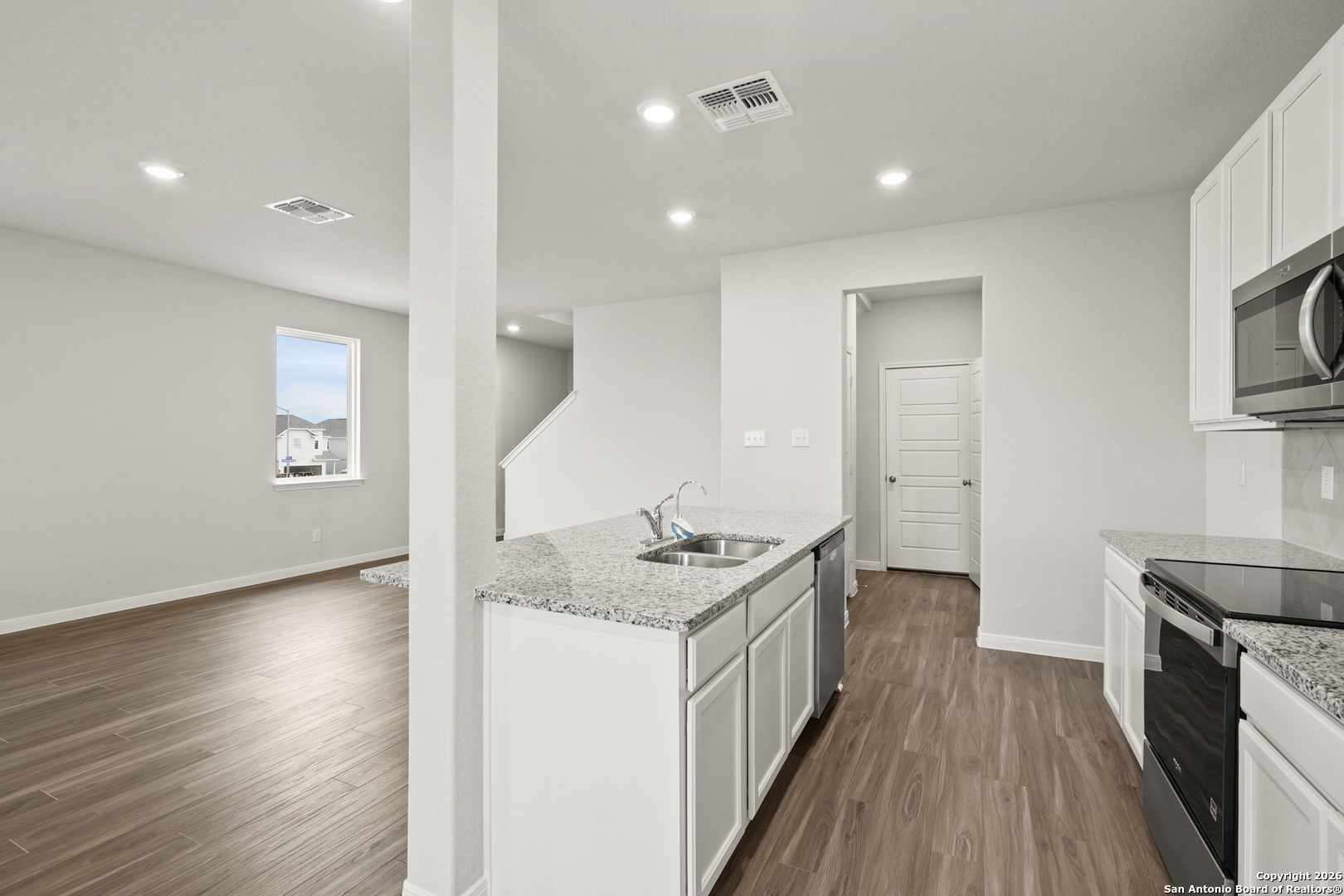 3215 Katzer Lane Converse, TX 78109 - Photo 6 of 23 a kitchen with stainless steel appliances granite countertop a sink stove and wooden floor